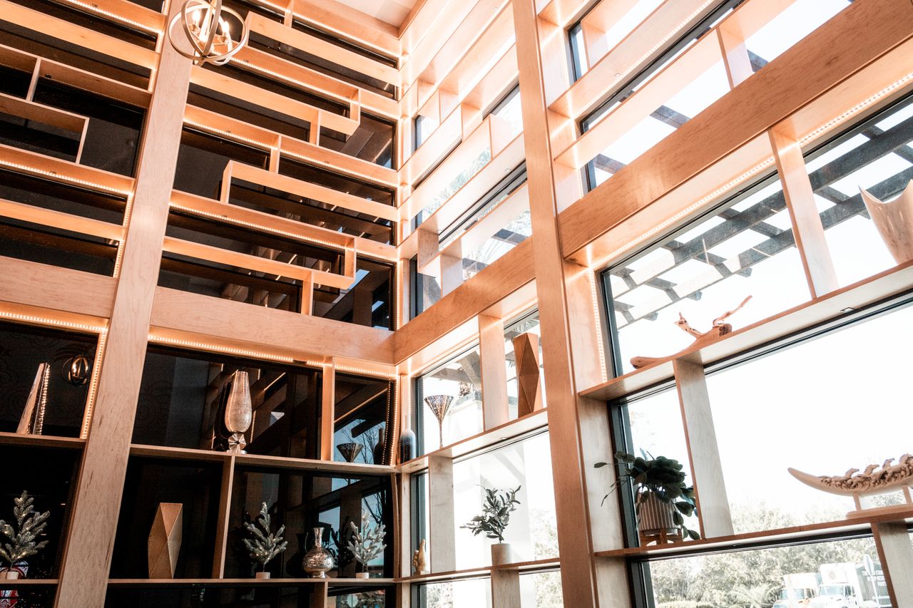 Home Stylish interior featuring wooden decor, glass panels, and elegant decor elements in natural light.